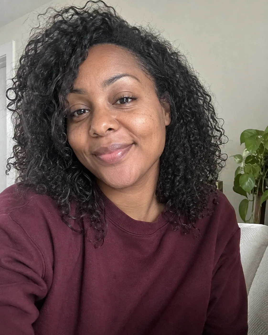 A client showing her finished hair after her appointment.